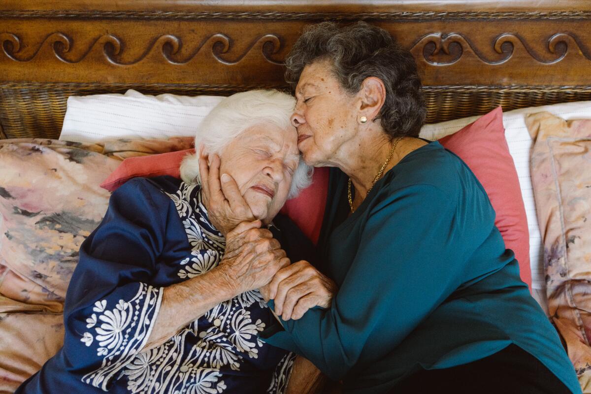 Lillian Faderman (right) holds Phyllis Irwin in their bedroom in their home in La Jolla, Calif.