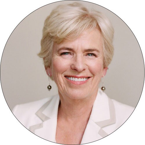 A professional head shot of an older woman with short hair.