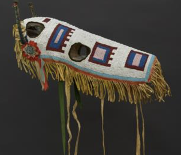 A horse covering with white beads and geometric shapes is part of an exhibit at the Plains Indian Museum.
