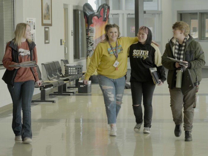 A teacher and three students walk down the hall of Cheyenne South High School.