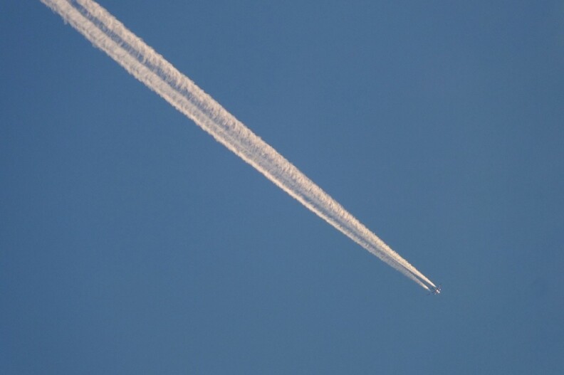 A white line in the sky following a plane.