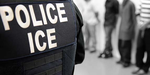 An ICE officer oversees an immigration enforcement operation in 2019.