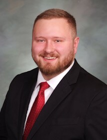 A profile picture of a man in a suit.