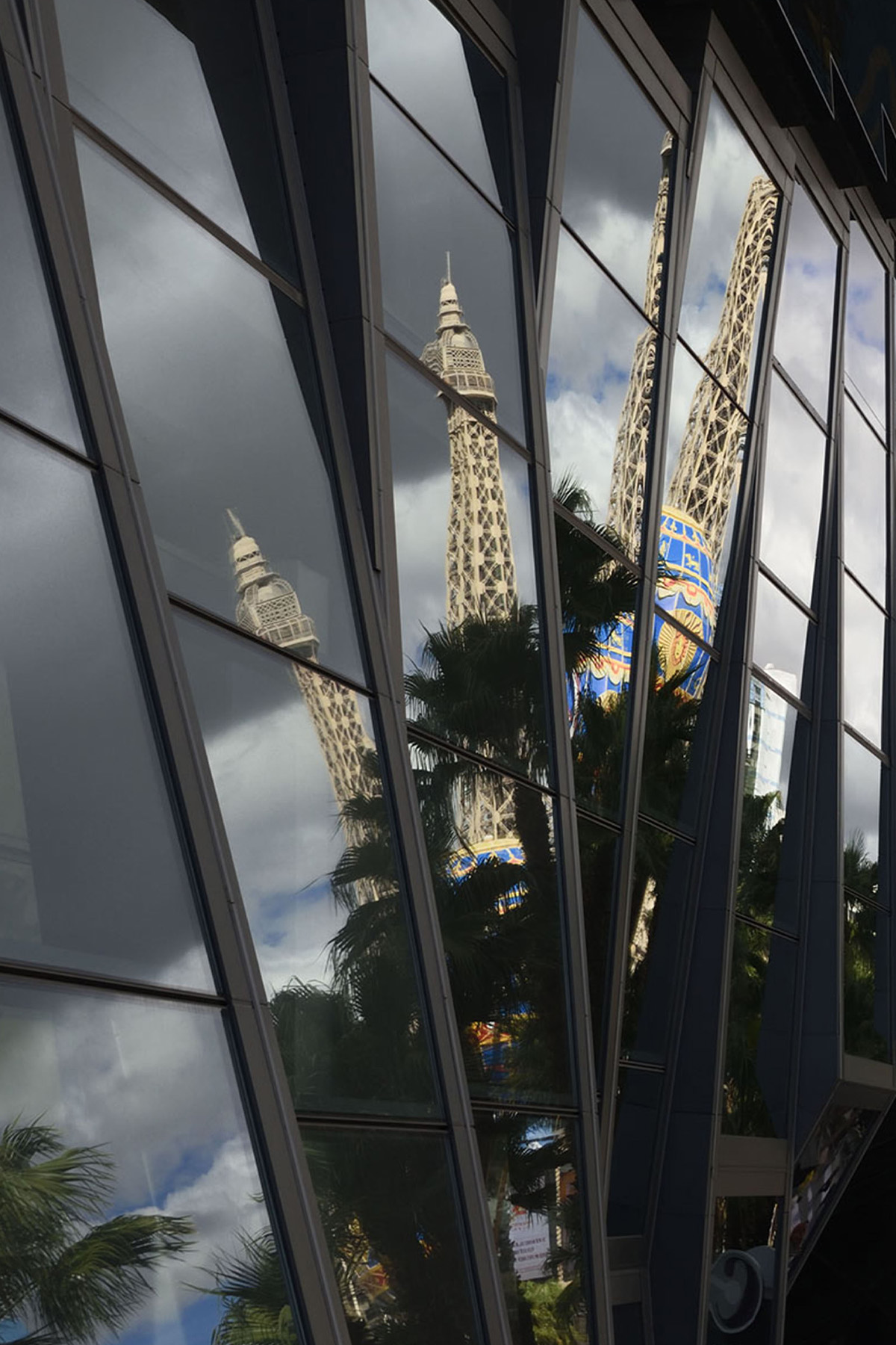 Reflection of Paris balloon in the window of a business on the Strip.