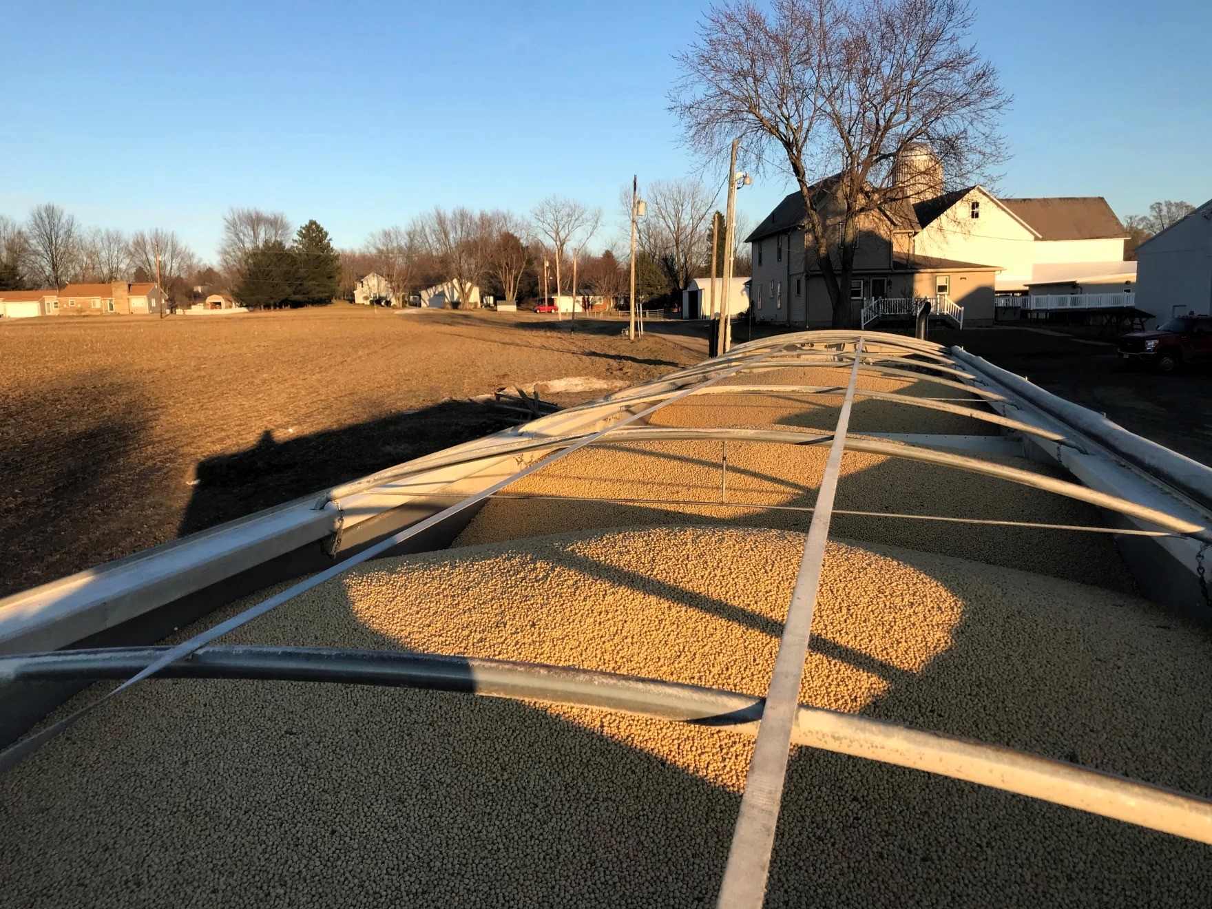 A full trailer of soybeans sits beside an empty field at a farm in Ohio in winter 2019.