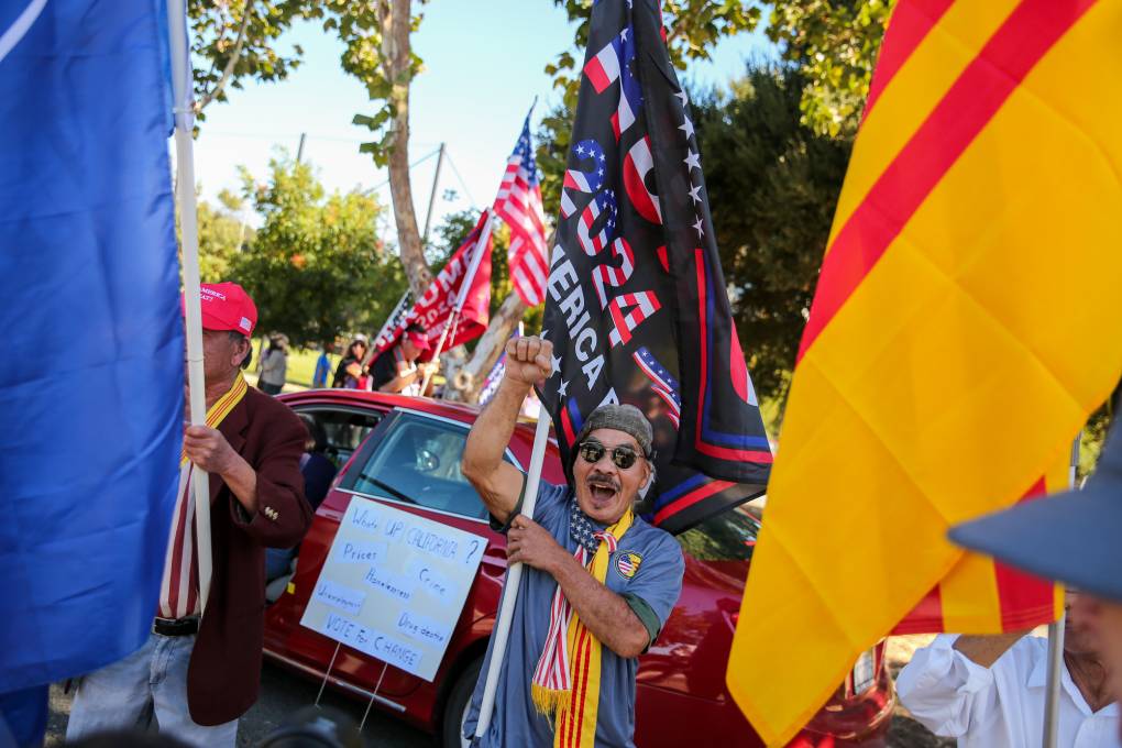Paul Nguyen of San José chants on the side of El Camino Real in Palo Alto during a rally supporting Donald Trump for President on Friday, Sept. 13, 2024. (Joseph Geha/KQED)