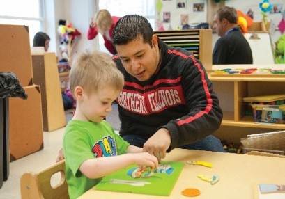 Instructor helping a young student with a learning puzzle