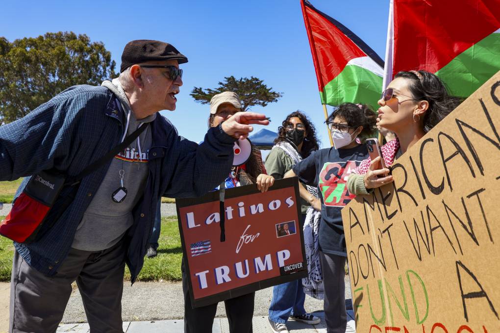 Angelica Davila (right) faces off with a counterprotester at Window on the Bay Park in Monterey on June 23, 2024. Ceasefire demonstrators and Former President Trump supporters rallied at the same park. (Gina Castro/KQED)<br>
