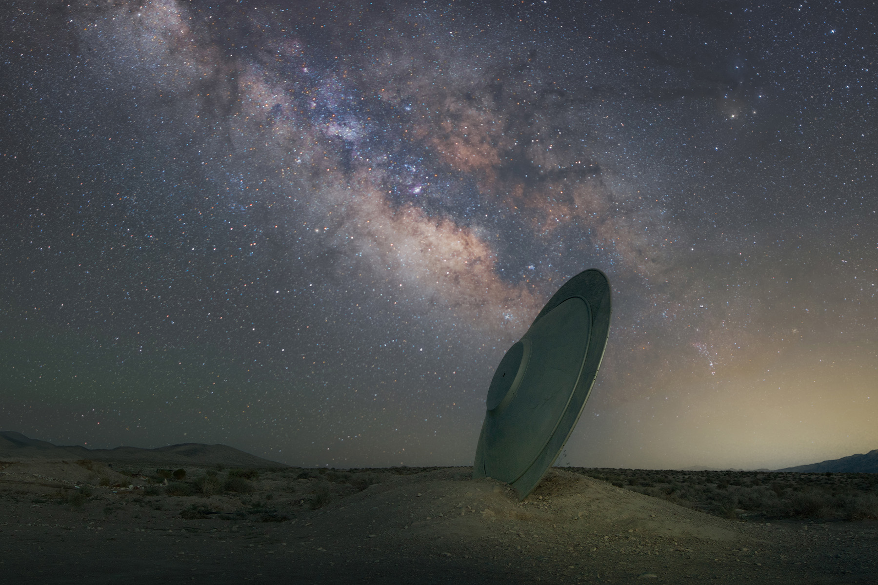 UFO art installation under a starry sky near Rachel.
