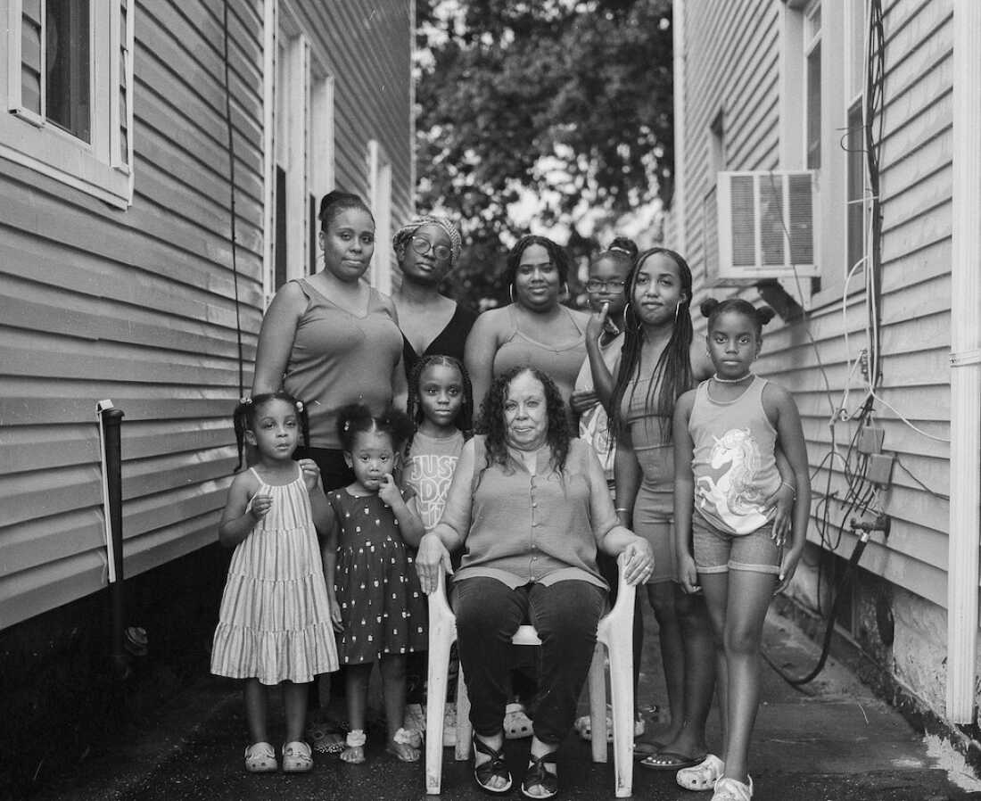 Stevens’ aunty Janice Reynolds, 74, the matriarch of the Stevens family, poses for a photo with the family's younger generations in the driveway of her childhood home in South Jamaica, a neighborhood in Queens, N.Y.