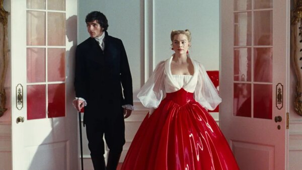 Jacob Elordi stands next to Margot Robbie in a still from the movie "Wuthering Heights." 