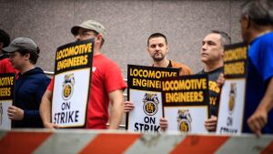 Members of the Brotherhood of Locomotive Engineers and Trainmen BLET Union Hold posters as they take part during a Strike outside NJ Transit's Headquarters on May 16, 2025 in Newark, N.J.