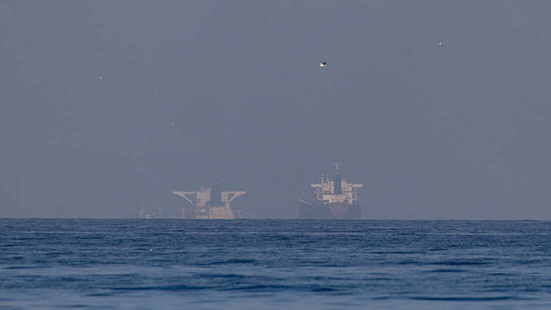 Commercial vessels are seen in the Gulf, near the Strait of Hormuz, in northern Ras al Khaimah, United Arab Emirates, on Sunday.