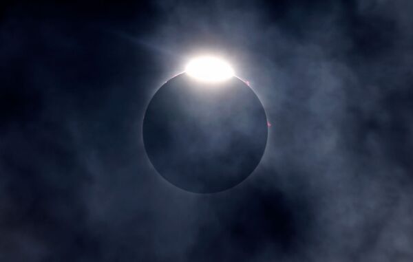 The diamond ring effect as well as Bailey's Beads are seen as the moon eclipses the sun on April 8, 2024 in Fort Worth, Texas.