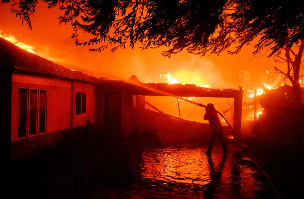 A firefighter douses flames during the Eaton Fire in Pasadena, Calif., on Jan. 8.