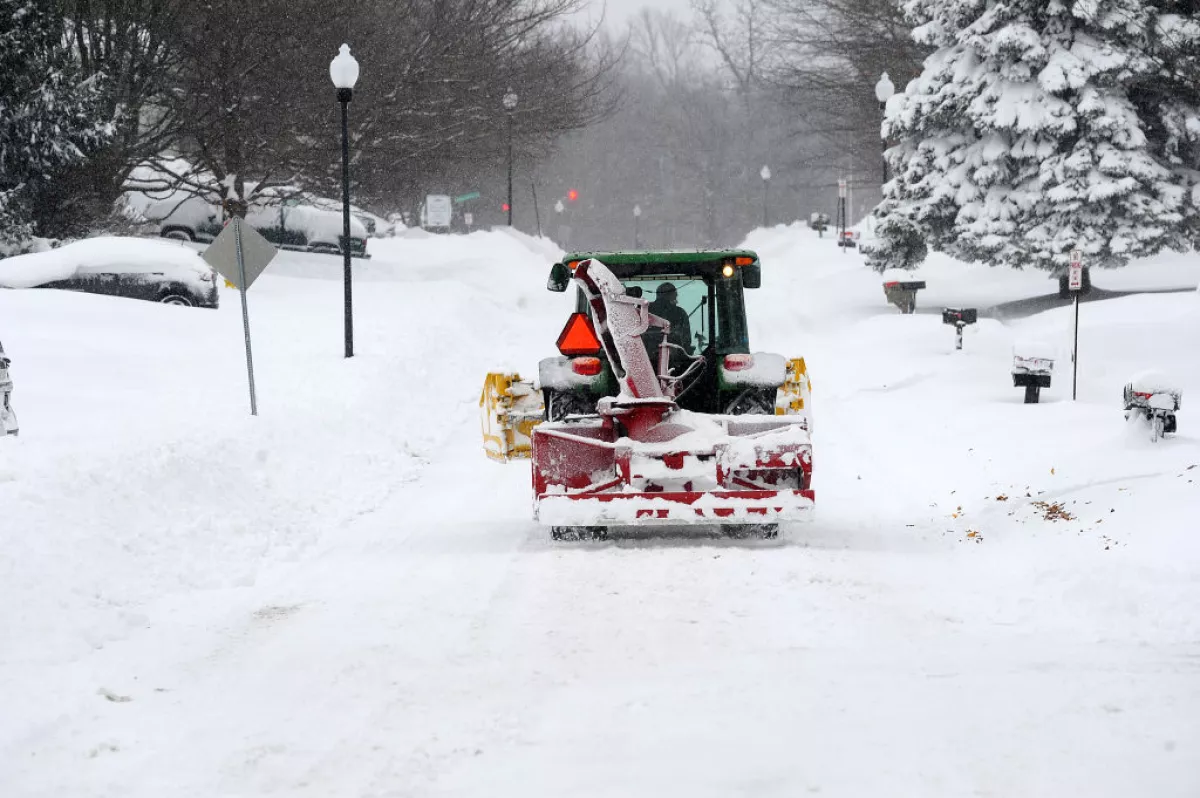 A snow removal machine makes its way along Nettle Creek Road after over two feet of heavy lake effect snow on Dec. 1, 2024 in Derby, New York.