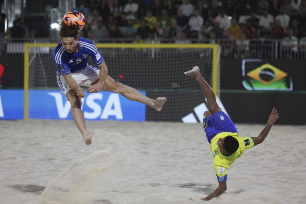 Datinha of Brazil does a bicycle kick Feb. 25 as Italy's Tommaso Fazzini defends during the FIFA Beach Soccer World Cup final between Brazil and Italy at the Dubai Design District Stadium in Dubai, United Arab Emirates. (AP)