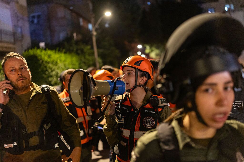 Police and first responders work at a scene where an apartment was damaged by a missile strike in the outskirts of Tel Aviv, Israel, on Wednesday.