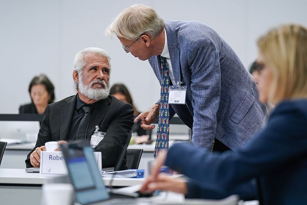 Martin Kulldorff (right) speaks with Robert Malone during a meeting of the CDC
