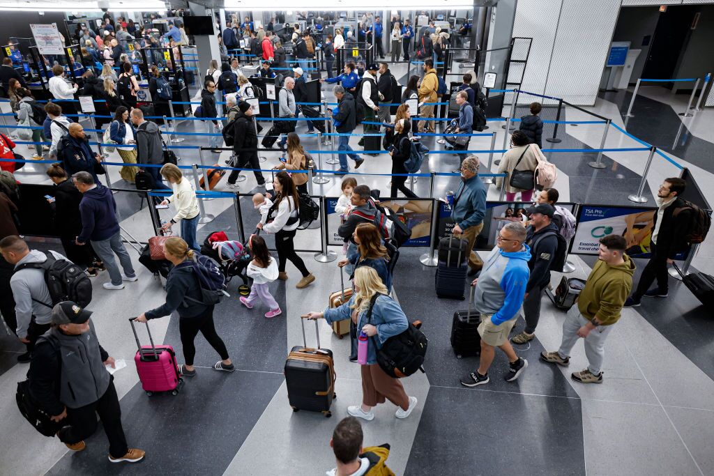 Travelers line up at the security checkpoint at O