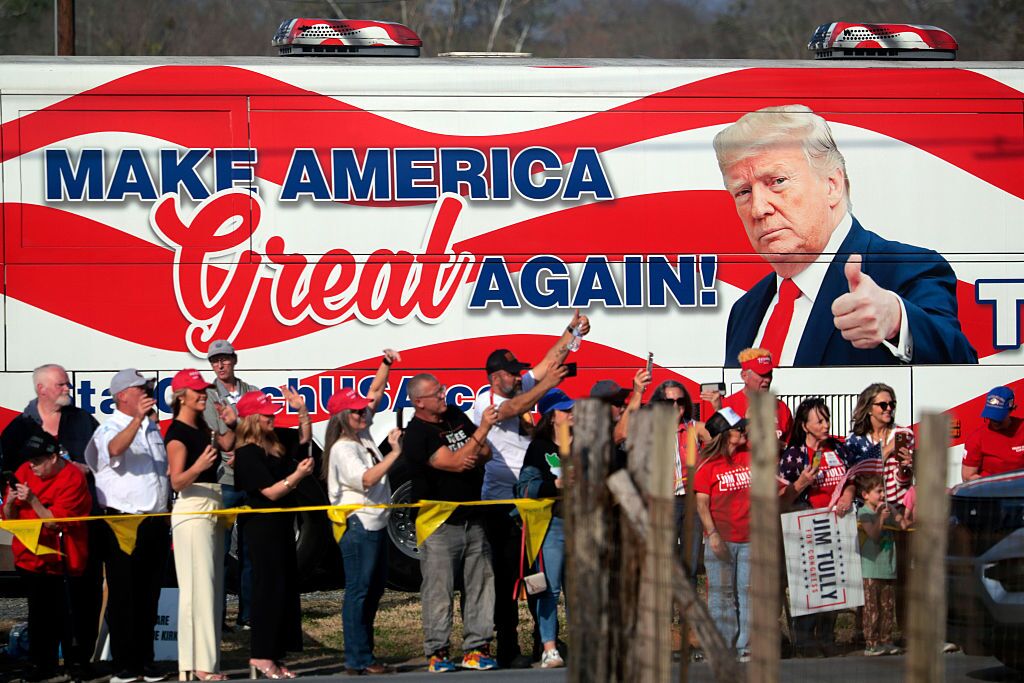 People cheer for President Trump en route to his speaking engagement at the Coosa Steel Corporation on Feb. 19 in Rome, Ga. Trump delivered remarks on the economy and affordability as the state started voting to replace the seat vacated by former Republican Rep. Marjorie Taylor Greene.