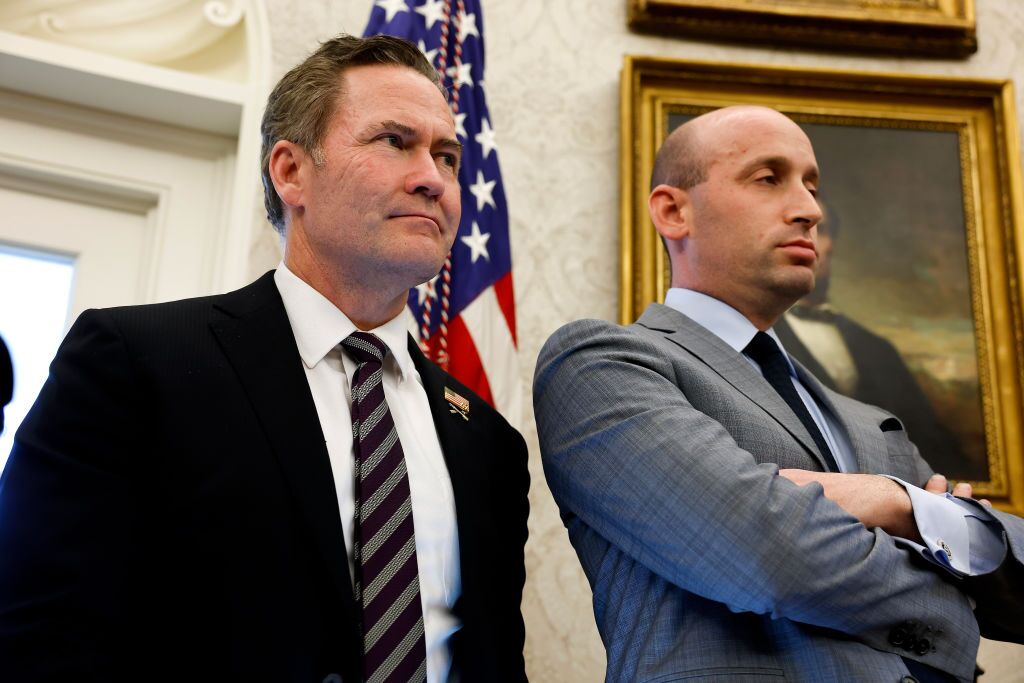 U.S. National Security Adviser Michael Waltz (L) and Deputy White House Chief of Staff for Policy Stephen Miller (R) look on as U.S. Pres. Donald Trump speaks with reporters after signing two executive orders in the Oval Office of the White House on Feb. 04, 2025. (Photo by Anna Moneymaker/Getty Images)