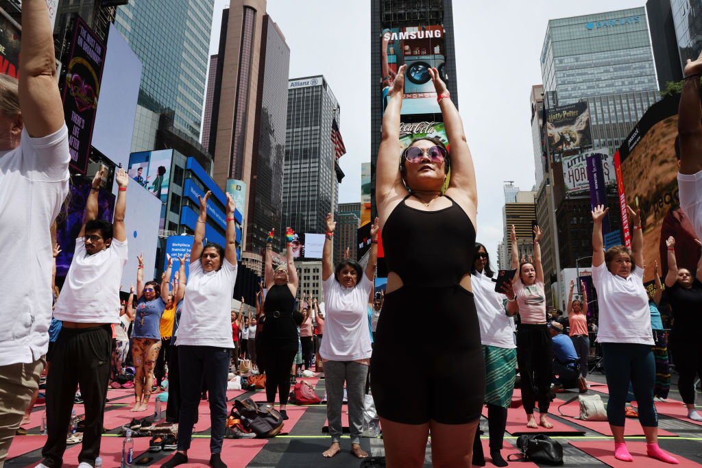 Enthusiasts Practice Yoga In New York's Times Square