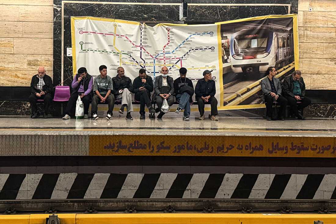 Commuters wait on the platform for their metro train to arrive in the capital Tehran on April 13, 2026.