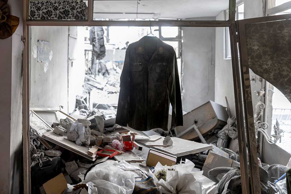 A shirt is seen hanging amidst the rubble in the Beryanak District after it was damaged by missile attacks two days before, on March 15, 2026 in Tehran, Iran.