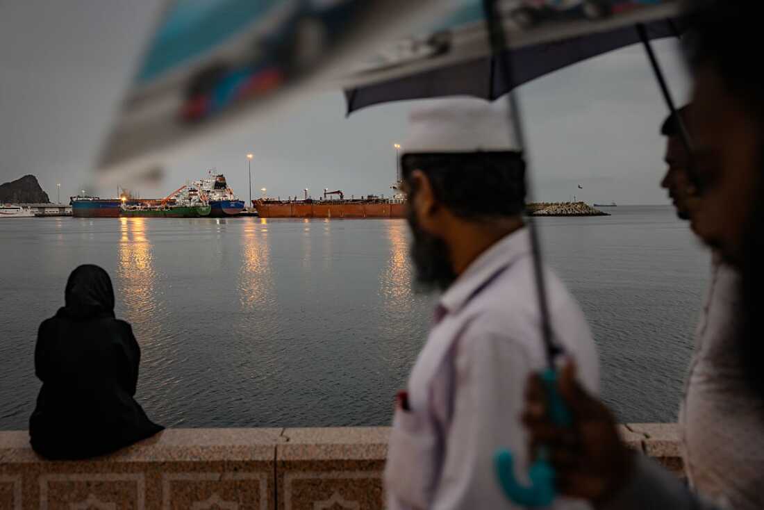 A bulk carrier sits anchored as families gather on the last day of Eid at Sultan Qaboos Port on March 23, 2026 in Muscat, Oman.