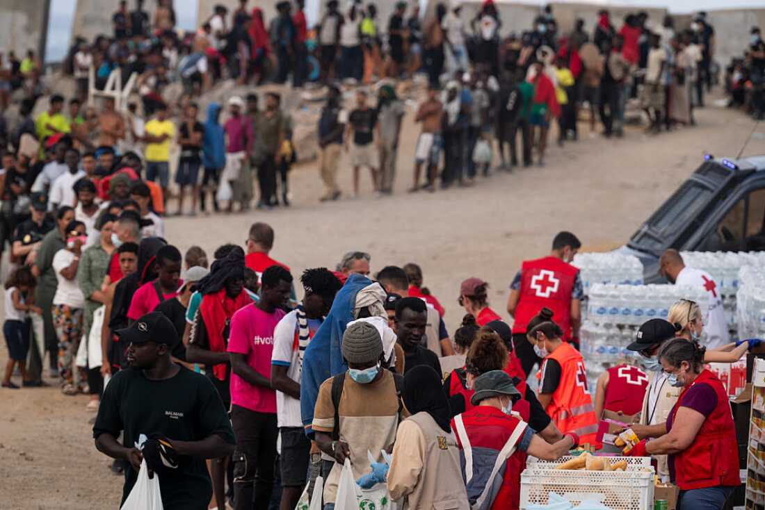 Migrants receive food and aid from the NGO's in El Trampolin Beach on August 14, 2026 in Ceuta, Spain.