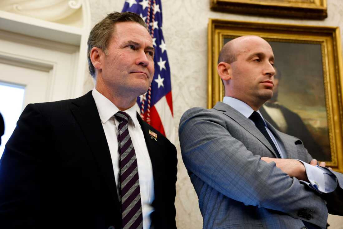 U.S. National Security Adviser Michael Waltz (L) and Deputy White House Chief of Staff for Policy Stephen Miller (R) look on as U.S. Pres. Donald Trump speaks with reporters after signing two executive orders in the Oval Office of the White House on Feb. 04, 2025.