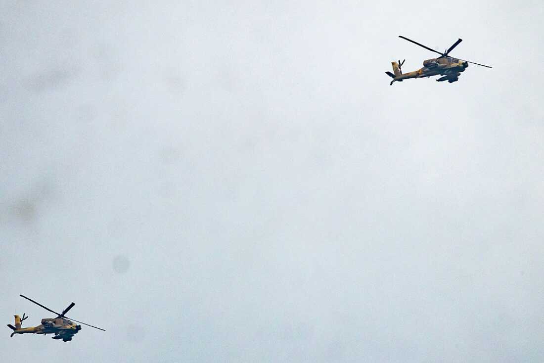 Israeli helicopter gunships fly along the Lebanon-Israel border in the Upper Galilee in northern Israel on March 22, 2026.