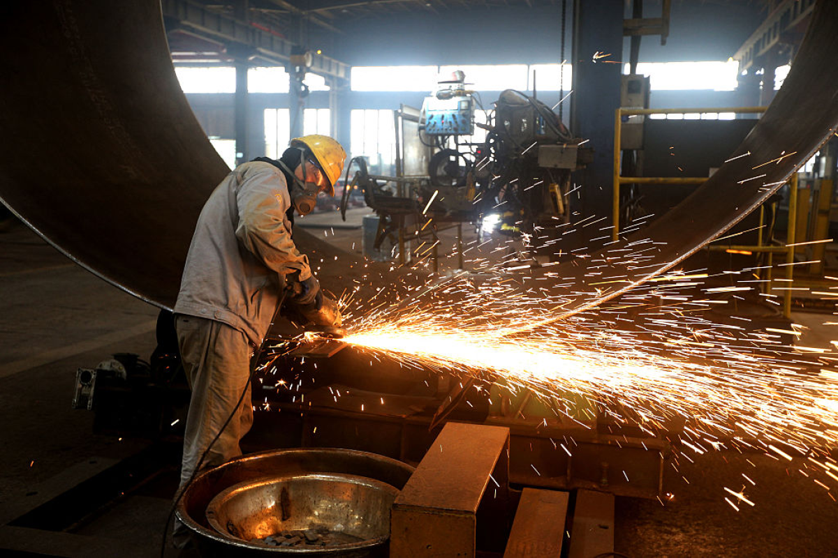 A worker makes part of wind turbines at a factory in Lianyungang, in China's eastern Jiangsu province on September 18, 2025.