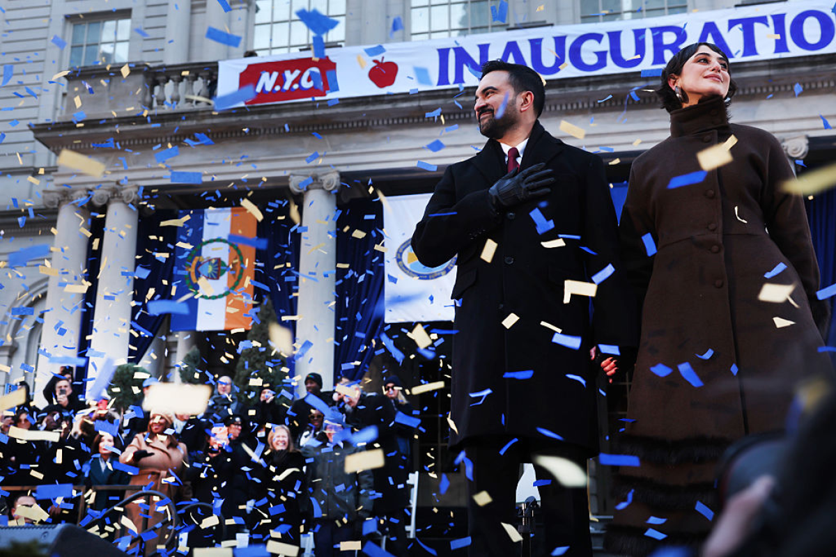 New York Mayor Zohran Mamdani stands on stage with his wife, Rama Duwaji, after he was ceremonially sworn in as New York City's 112th mayor at City Hall on Thursday.