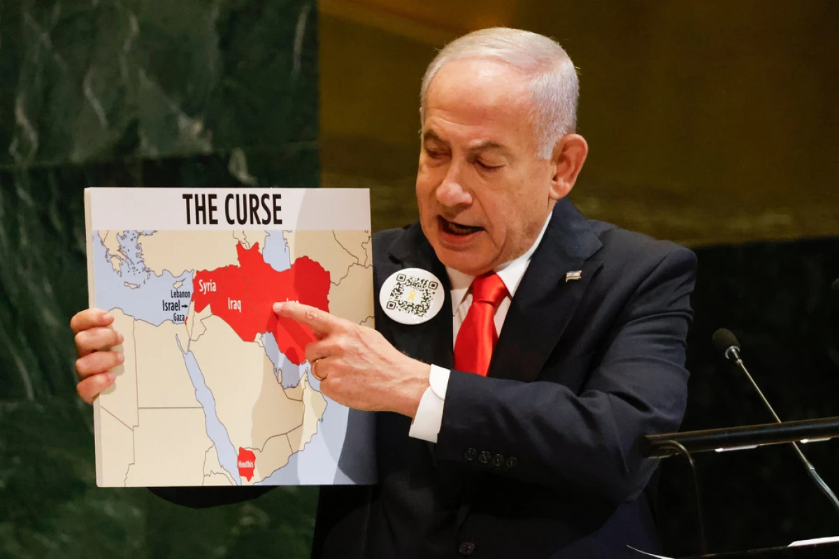Israeli Prime Minister Benjamin Netanyahu holds up a map Friday while speaking at the 80th session of the United Nations General Assembly, at U.N. headquarters.
