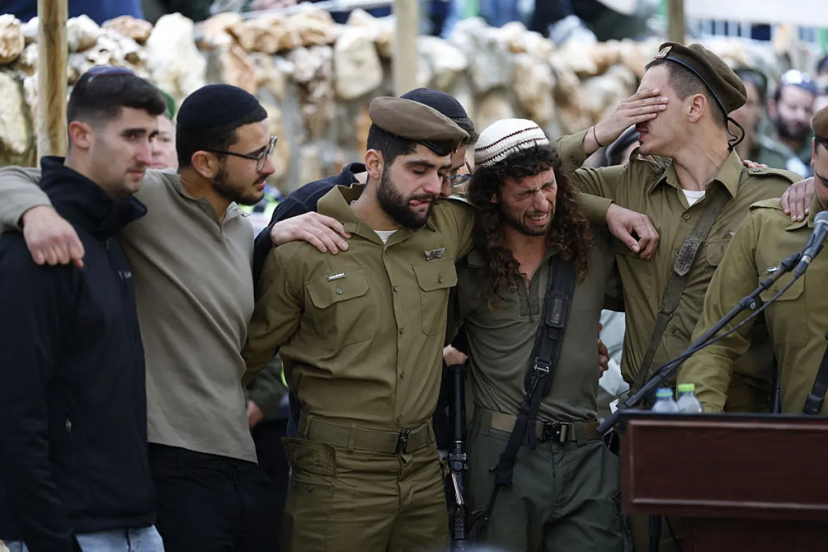 Israeli soldiers grieve during the funeral of Staff sergeant Ori Greenberg, 21, at the Mount Herzl military cemetery in Jerusalem on March 26, 2026.