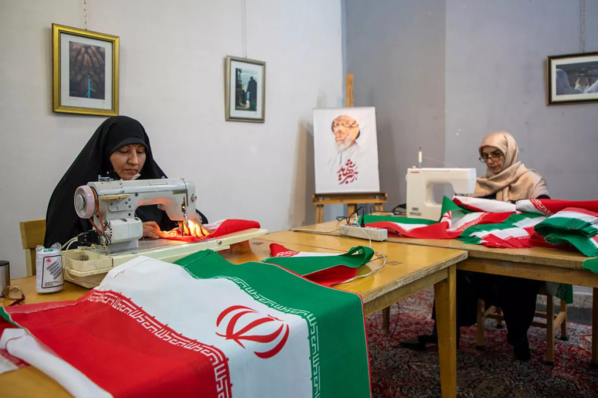Volunteers sew Iranian flags to distribute across the city for free, on April 5, 2026, in Tehran, Iran. According to the team's manager, up to 5,000 flags are distributed daily.