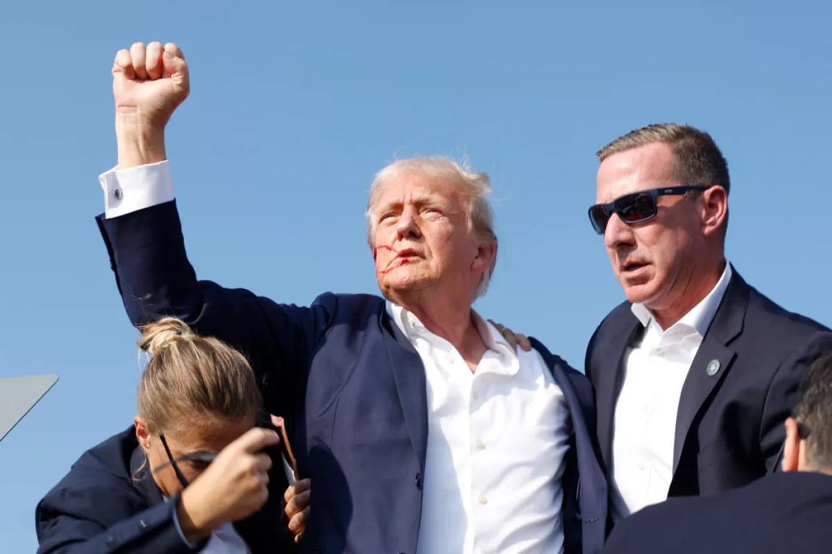 Former President Donald Trump is rushed offstage during a rally in in Butler, Pa.