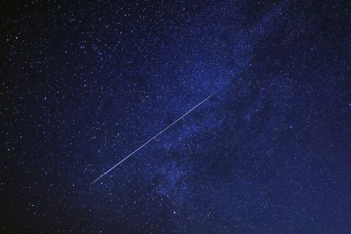 A meteor burns up in the sky over al-Abrak desert north of Kuwait City during the annual Geminid meteor shower early on Dec. 15, 2023.
