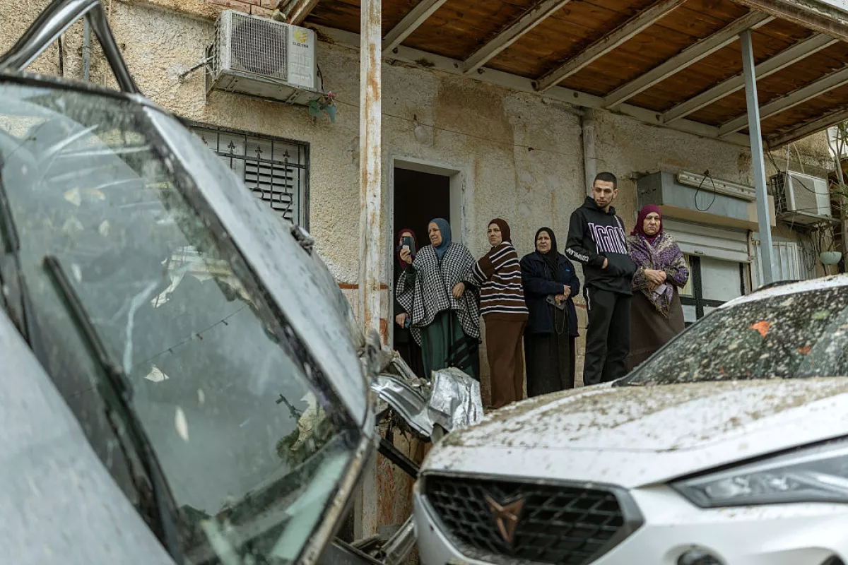 Arab-Israeli residents surveys the damage following a projectile strike in the Arab-Israeli city of Kfar Qassem on March 26, 2026.