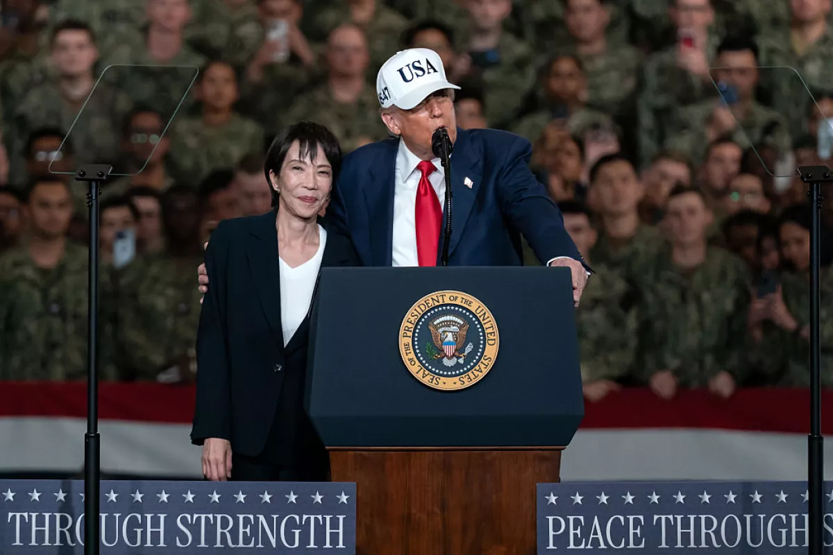 Japanese Prime Minister Sanae Takaichi (R) listens as U.S. President Donald Trump (L) speaks to troops aboard USS George Washington on October 28, 2025 in Yokosuka, Japan.