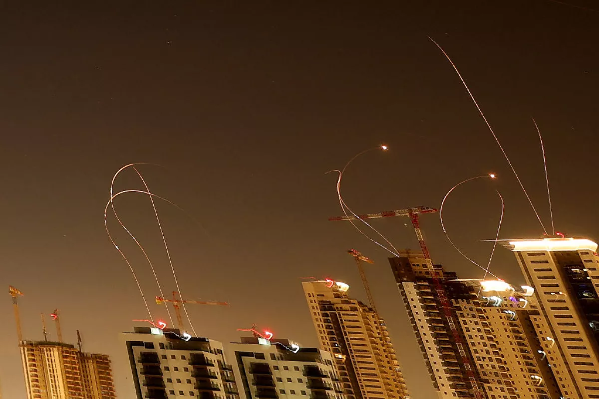 Rocket trails are seen in the sky above the Israeli coastal city of Netanya amid a fresh barrage of Iranian missile attacks on March 24, 2026.