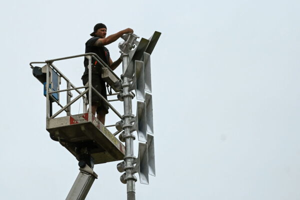 A worker installs flood warning sirens in western Germany in 2022, almost one year after the region was devastated by floods.