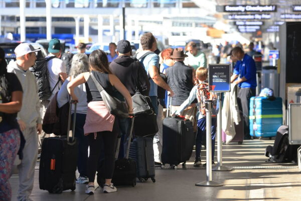 Crowds wait in checking line at Los Angeles International Airport on Nov. 21, 2023, in Los Angeles, as people travel ahead of the Thanksgiving holiday.