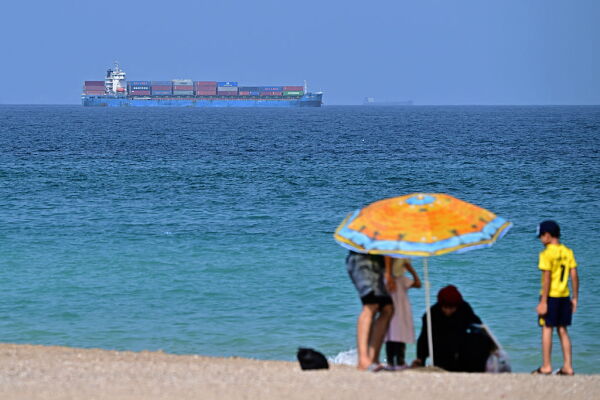 A cargo ship is pictured off coast of the Khor Fakkan Container Terminal, the only natural deep-sea port in the region and one of the major container ports in Sharjah Emirate, along the Gulf of Oman on June 28.