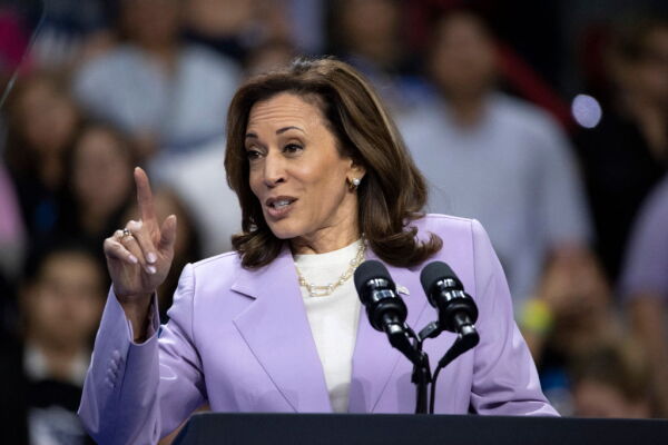 Democratic presidential nominee Kamala Harris speaks during a campaign rally at the University of Nevada in Las Vegas on Aug. 10. Wearing a lavender blazer, she's standing behind a lectern with microphones attached to it, while a crowd of supporters is in the background.