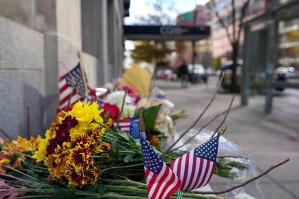 A makeshift memorial of flowers and American flags stands outside the Farragut West Metro station on Saturday in Washington, D.C.