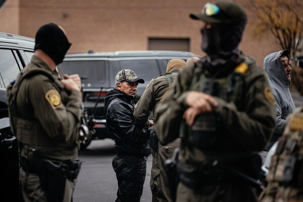 People detained earlier in the day are taken to a parking lot on the far north side of the city before being transferred to an Immigration and Customs Enforcement facility on Oct. 31, 2025, in Chicago.
