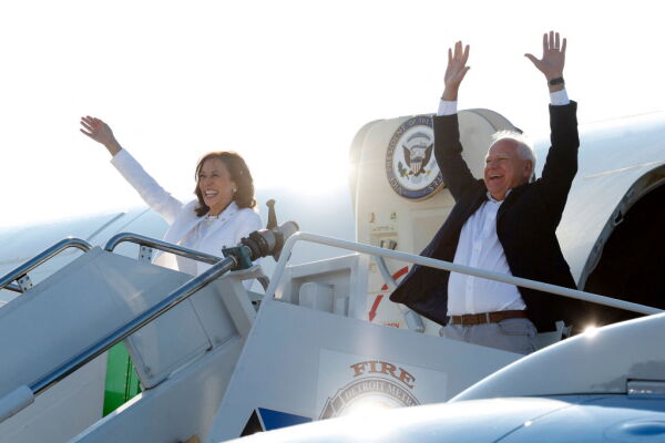 Vice President Harris and her running mate, Minnesota Gov. Tim Walz, wave as they disembark Air Force 2 for a campaign rally at Detroit Metropolitan Airport in Michigan, August 7, 2024. (Photo by JEFF KOWALSKY / AFP) (Photo by JEFF KOWALSKY/AFP via Getty Images)